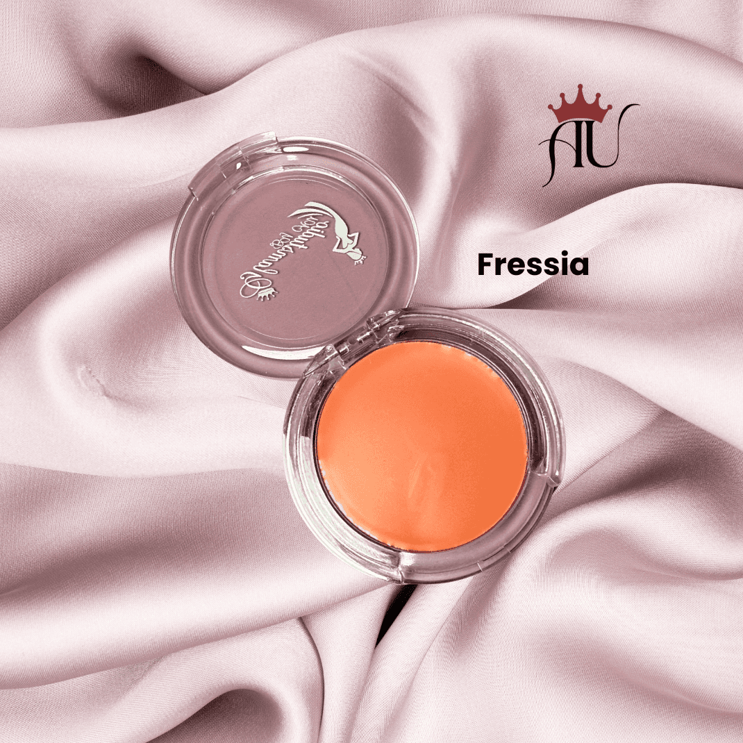 Fressia Cream Blush soft rosy-pink hydrating cream blush with natural dewy finish in clear compact on pink fabric background