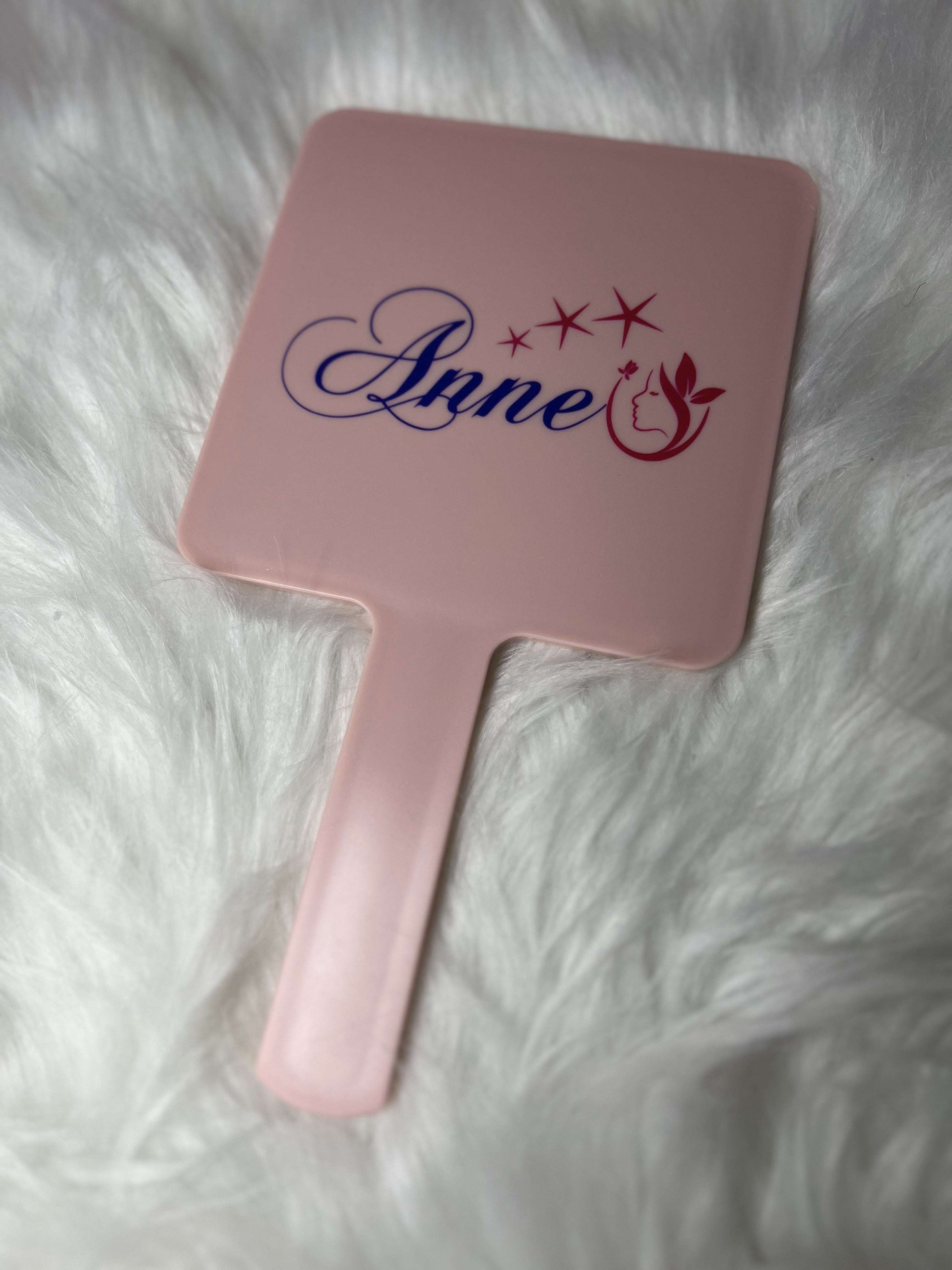 Elegant pink handled portable makeup mirror by Glam Studio with ergonomic grip and stylish square design